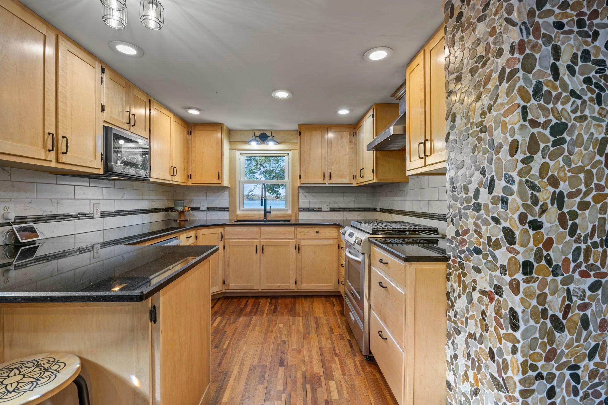 Updated kitchen with hickory cabinets and granitw countertops