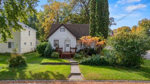 Situated on a corner lot with charming curb appeal and mature shrubs