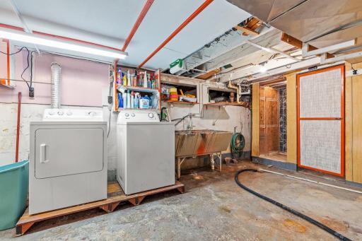 Laundry, utility sink, and shower and sink in basement