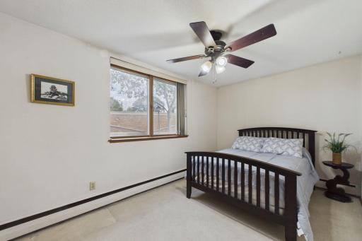 Comfortable primary bedroom offering generous space, natural light, and a ceiling fan for added comfort.