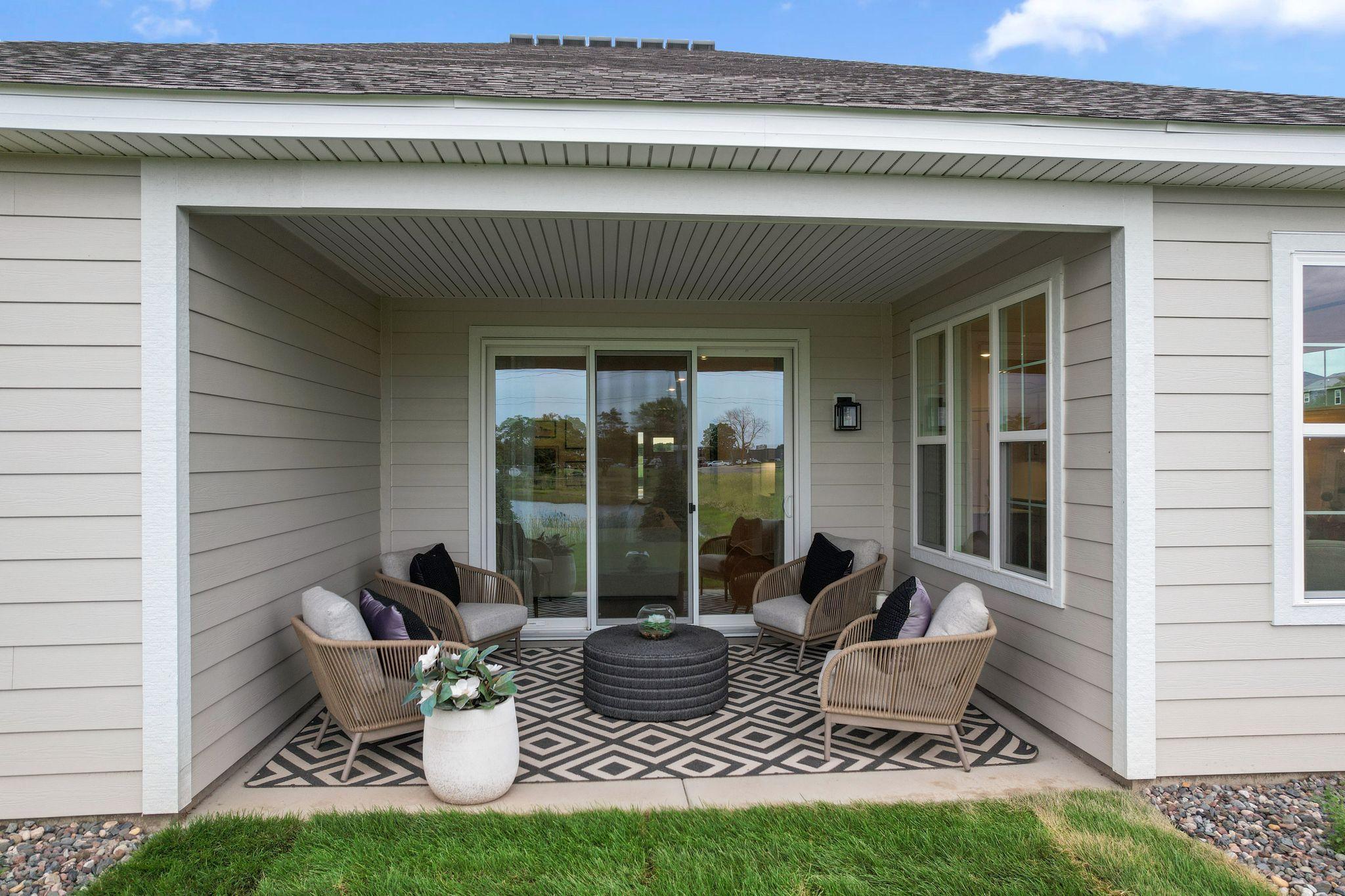Covered patio is the perfect space to enjoy a beautiful day in Minnesota! *Photo of model home- design and structural options may vary.