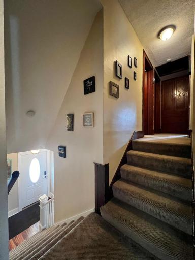 Stairway to additional Full Bath and 3 Bedrooms.