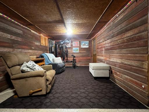 Basement Family Room with Barnwood Accent Walls and Doorway to the Utility Room.