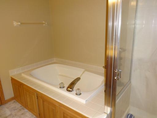 11 - Primary bath with large tub and separate shower.JPG