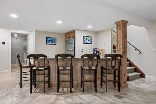There is also a full bar with a large fridge and room to sit