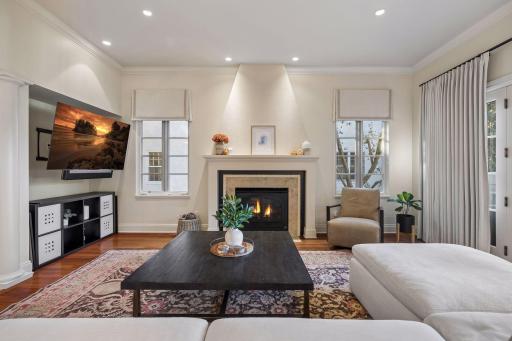 Large windows and hardwood flooring create a space of comfort and style