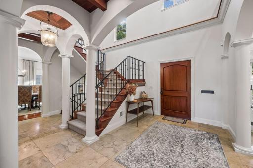 Enter into a grand enterance with tile floors, high ceilings, and space!