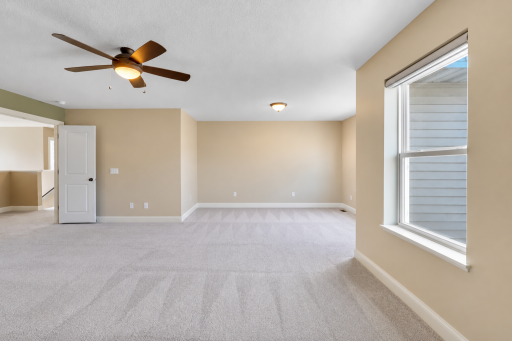 Spacious primary bedroom offering a generous, flexible layout with plenty of room for a king-size bed, additional furnishings, or a comfortable sitting area.