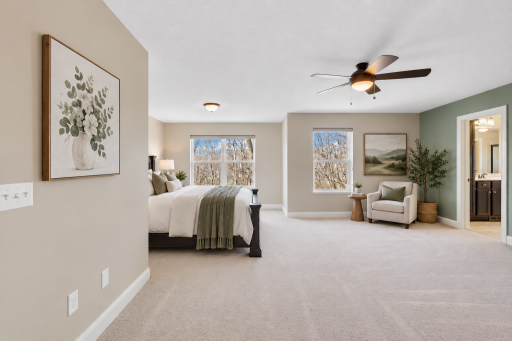 Spacious primary suite offering an impressive amount of room for both a comfortable sleeping area and additional seating or relaxation space.