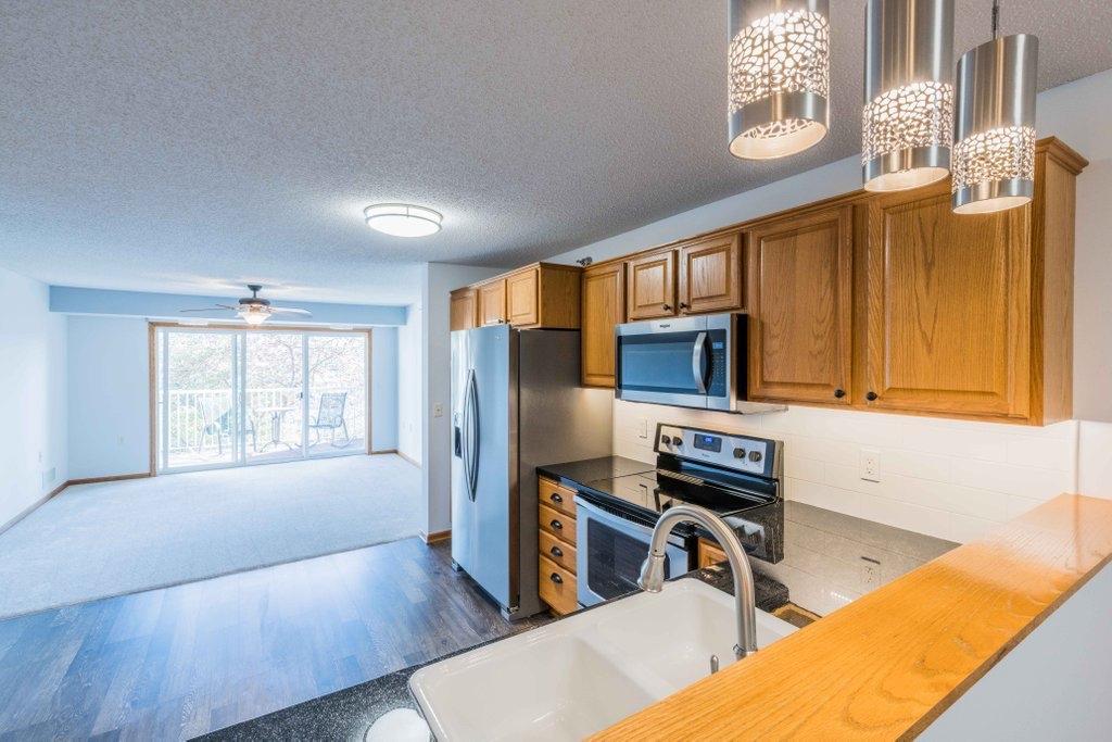 Open Concept from Kitchen to Living Room; half wall in photo delineates the dining room and kitchen.
