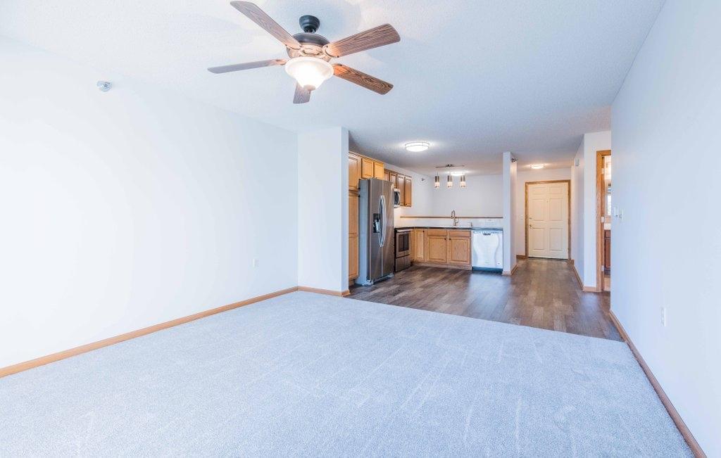 The best of both worlds: vinyl plank flooring from the door through kitchen and carpet in the living room.