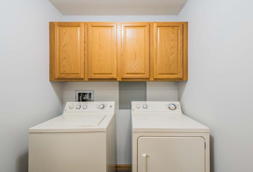 This unit features a separate laundry room with upper cabinets.