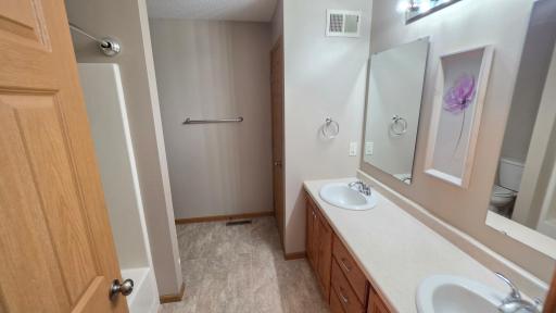 Double sinks in the bathroom with plenty of storage.