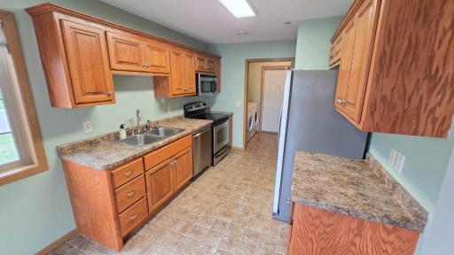 Galley kitchen leading to laundry and garage.