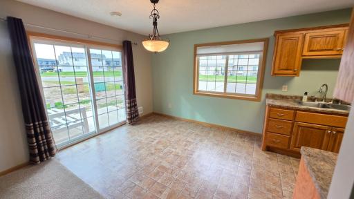 Plenty of natural light in the dining room, and a concrete patio outside!