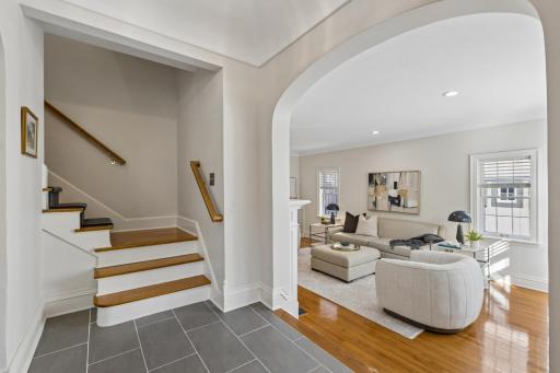 Graceful archways and hardwood floors throughout the main level