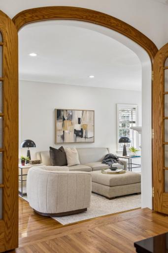 Original woodwork arch frames the living room