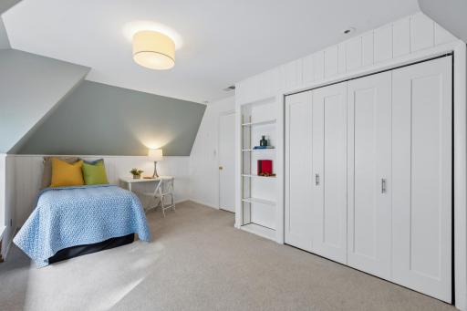Spacious third bedroom with built-in shelves and closet.
