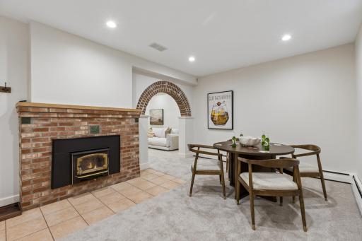 Lower-level recreation room with brick fireplace