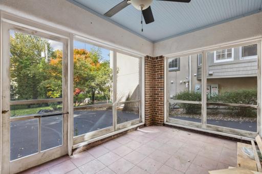 Lower-level screened porch with brick accent wall