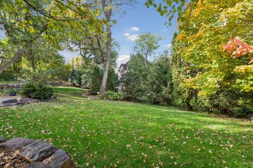 Private backyard with mature trees and fall color