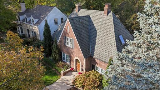 Aerial view of the Tudor roofline and landscaped front. New roof being installed.