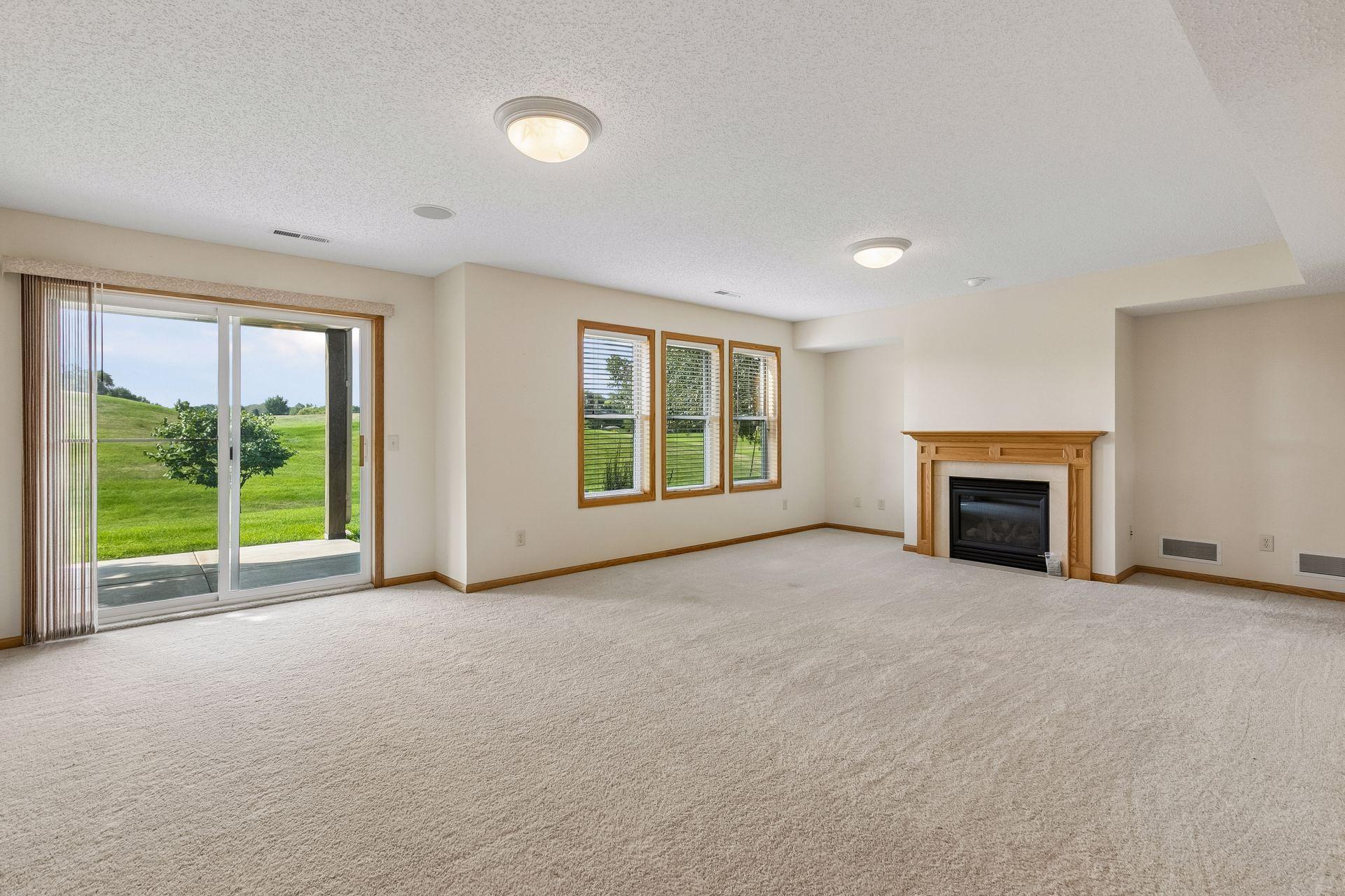 wide open lower level family room with a golf course view