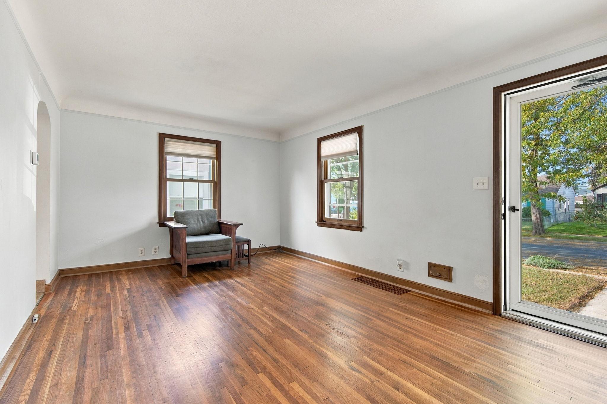 Hardwood flooring throughout the main-level living area and in both main-floor bedrooms.