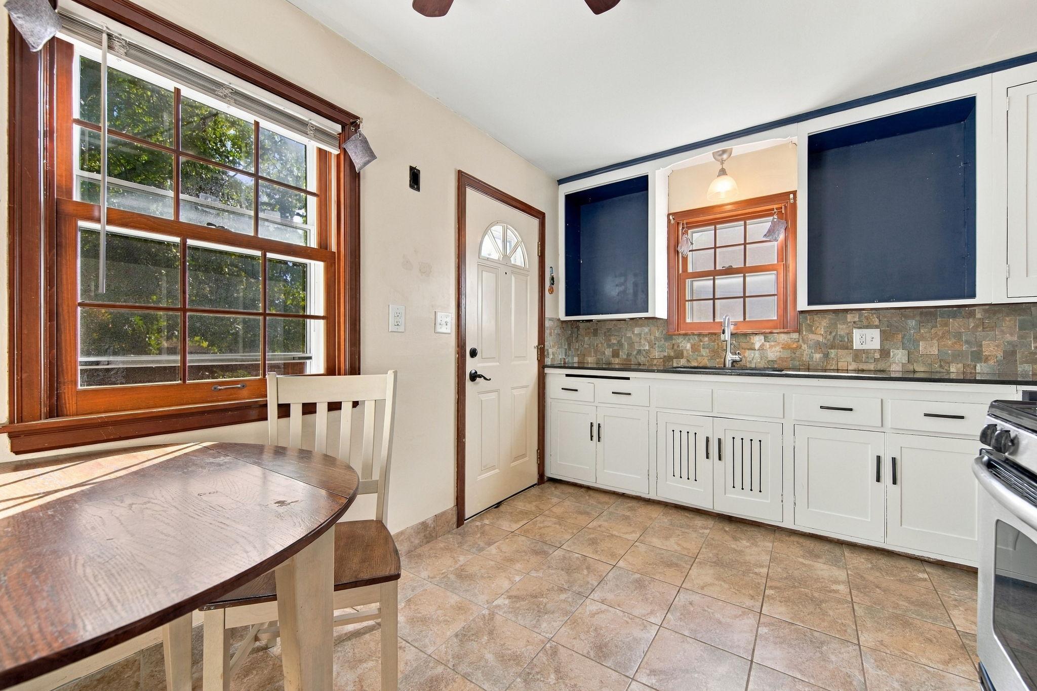 Eat-in kitchen featuring freshly painted cabinets.