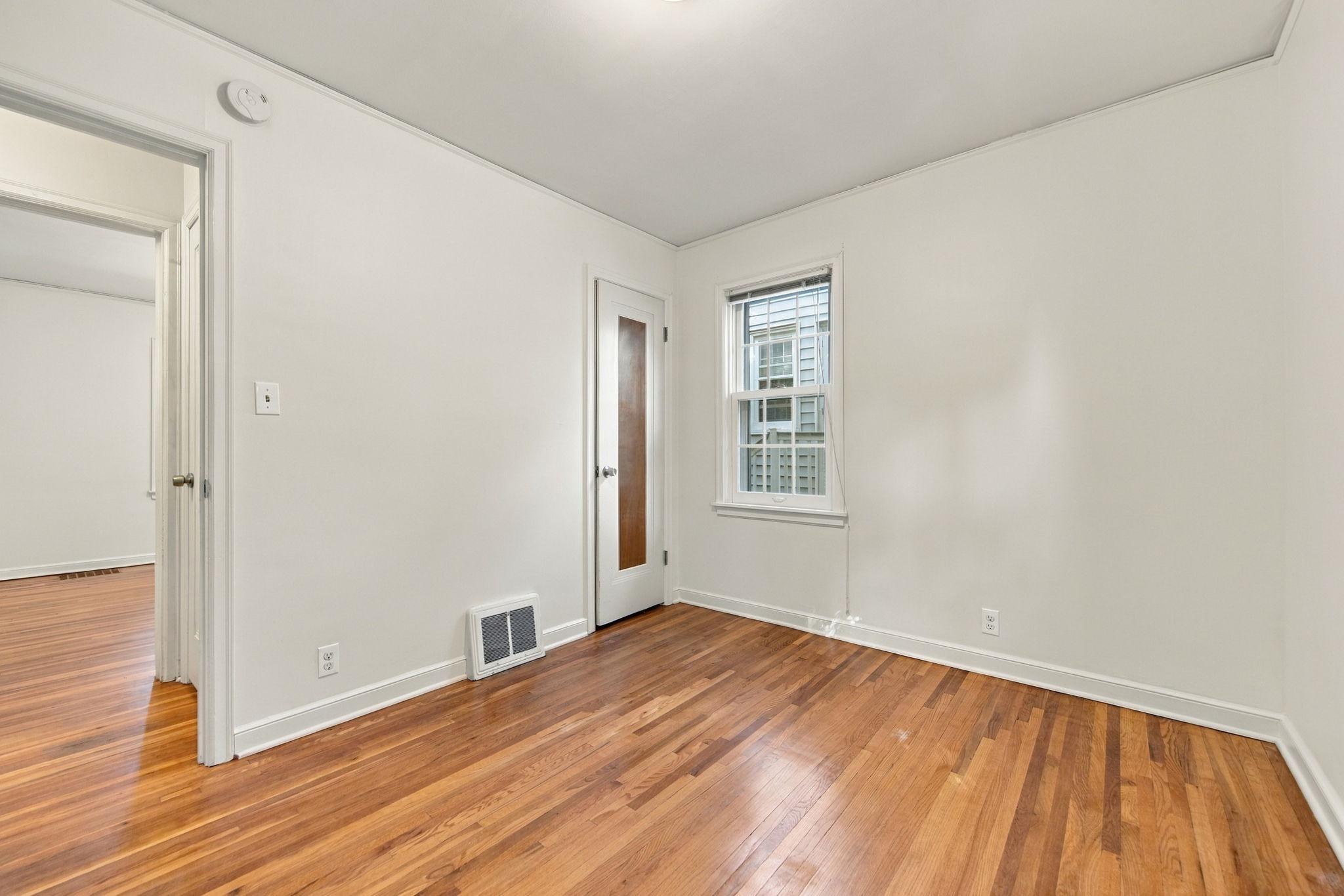 The second main-floor bedroom features beautiful hardwood floors and overlooks the backyard. The other main-floor bedroom also offers a view of the fenced-in yard. Either room would make an ideal bedroom, study, or music room.