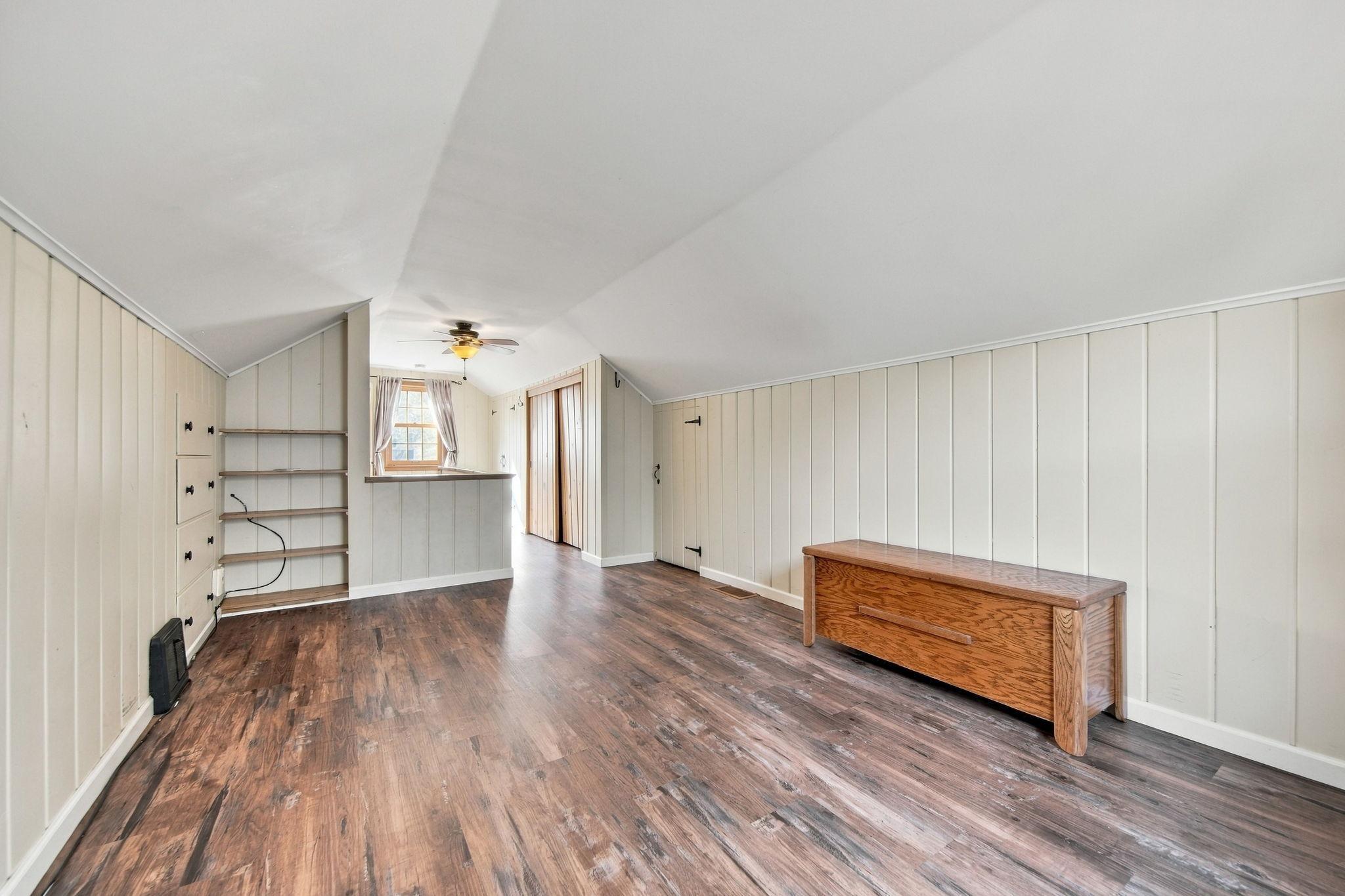 The upstairs bedroom also features attractive, low-maintenance flooring, a flat ceiling, and abundant storage.