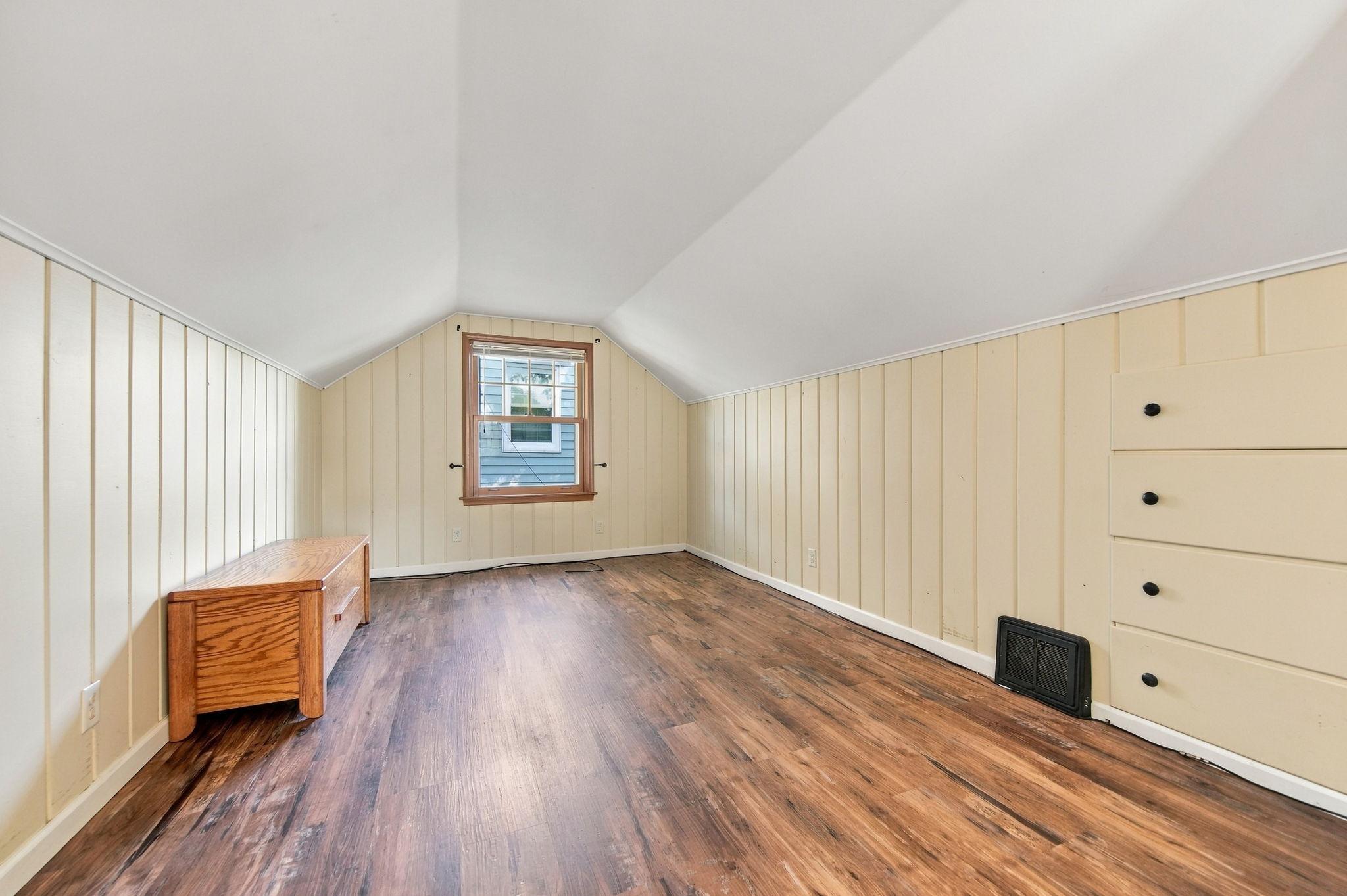 This spacious 16' x 12' bedroom features a large walk-in closet. The owners are happy to leave the window air conditioners for the next owners to enjoy.