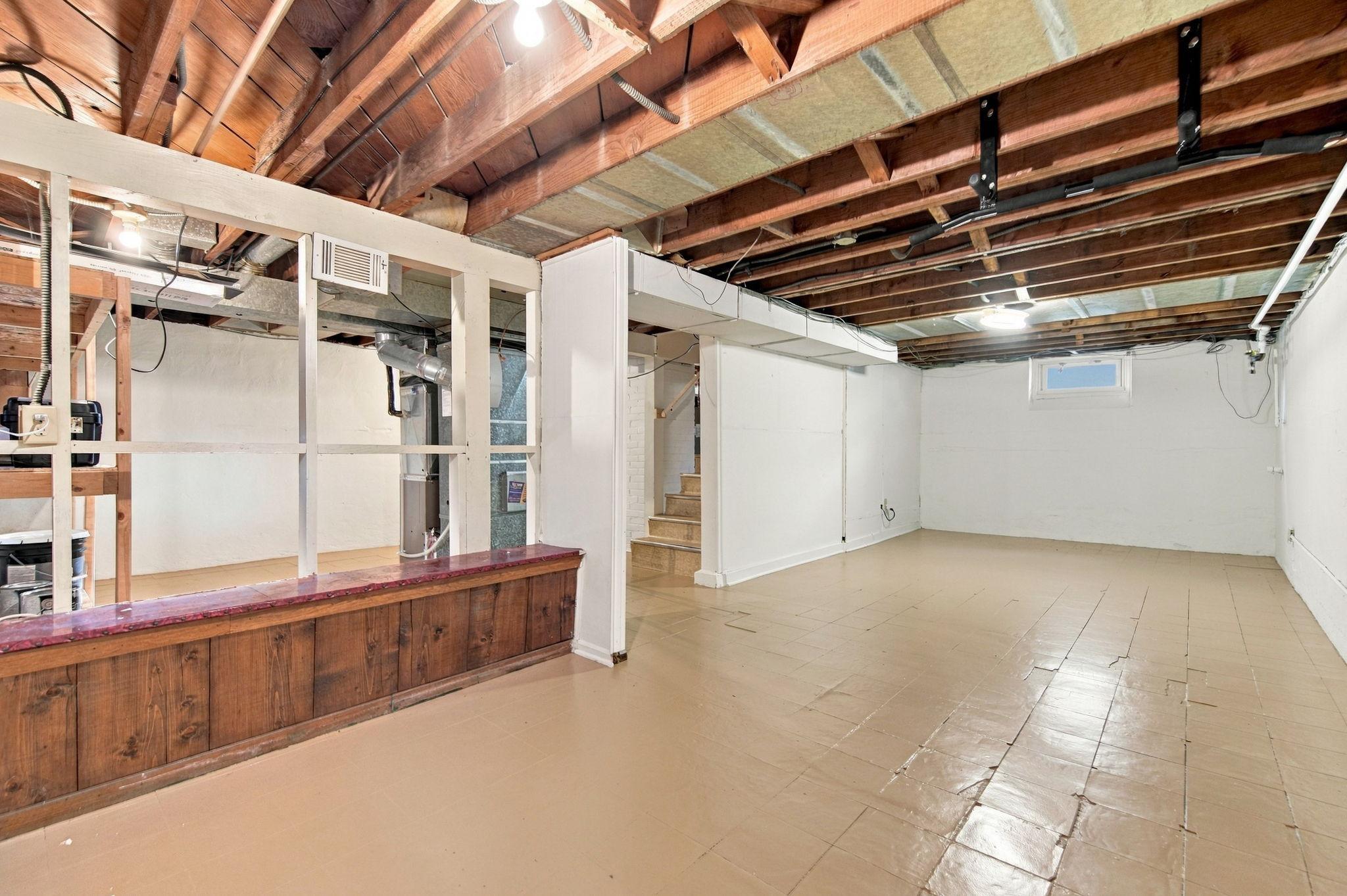 The lower level features new block windows, a new furnace, a new water heater, and new A/C.