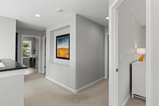 Upper Level boasts Four Spacious Bedrooms, Two Full Bathrooms, Large Laundry Room and Loft