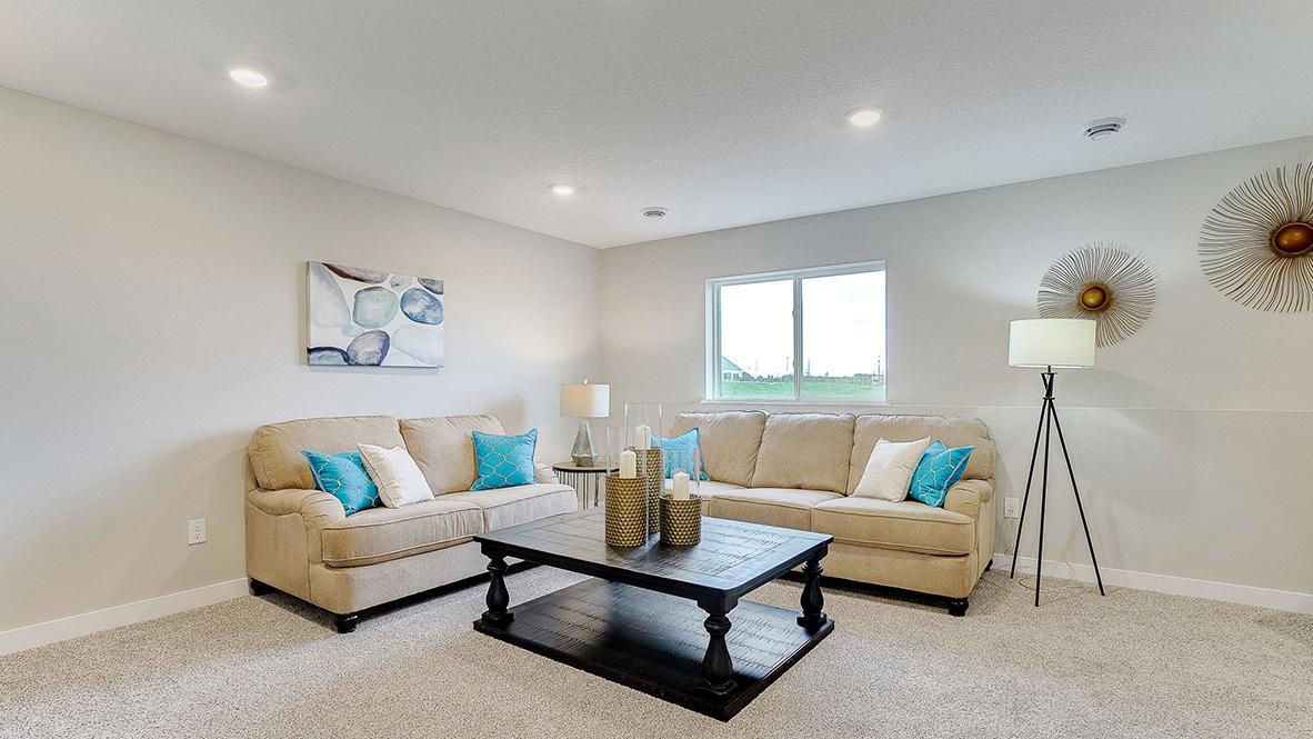 This is a finished basement in a model home; shown in order to give buyer an idea of what the basement space could look like once finished. The basement shown in these photos is of a lookout basement.