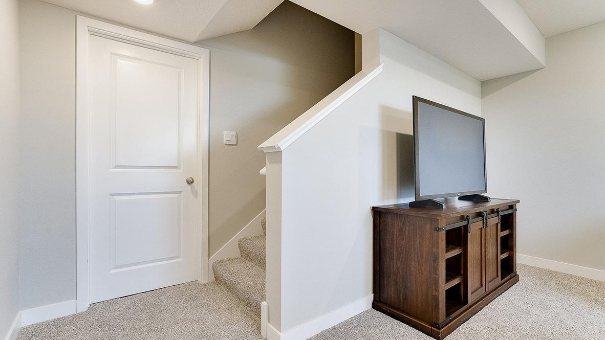 This is a finished basement in a model home; shown in order to give buyer an idea of what the basement space could look like once finished. The basement shown in these photos is of a lookout basement. Home listed is a lookout and is unfinished.