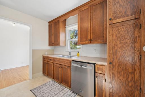 Kitchen with stainless dishwasher, deep double sink, and bright south-facing window