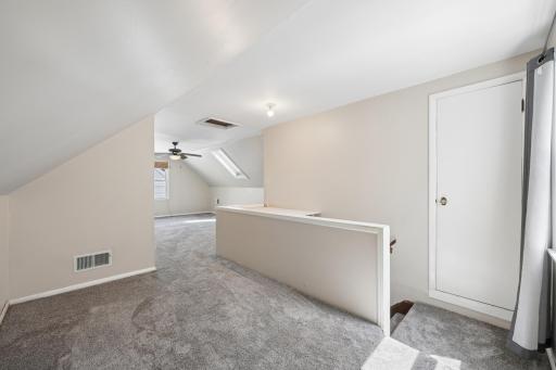 Upper-level landing with new 2025 carpet and skylight