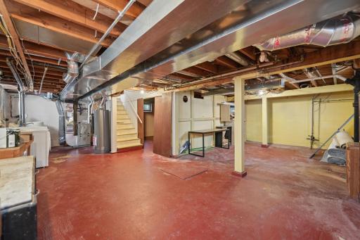 Lower level with stair access â clean, dry, and ready for storage or future finish