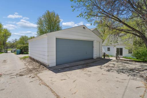 Detached two-car garage with matching trim and wide concrete approach