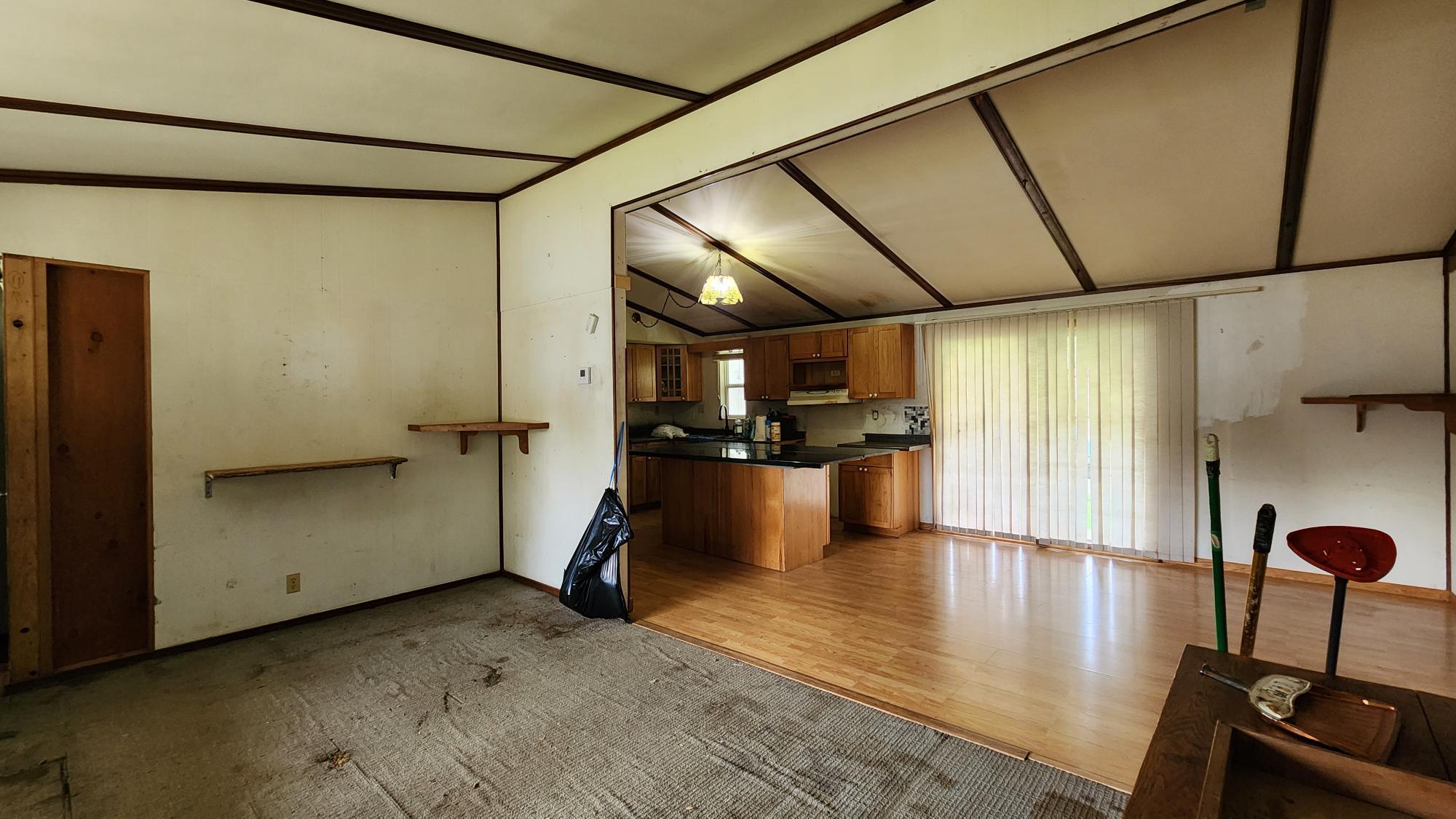 facing the dining area from the living room, sliding glass doors go out to a covered porch