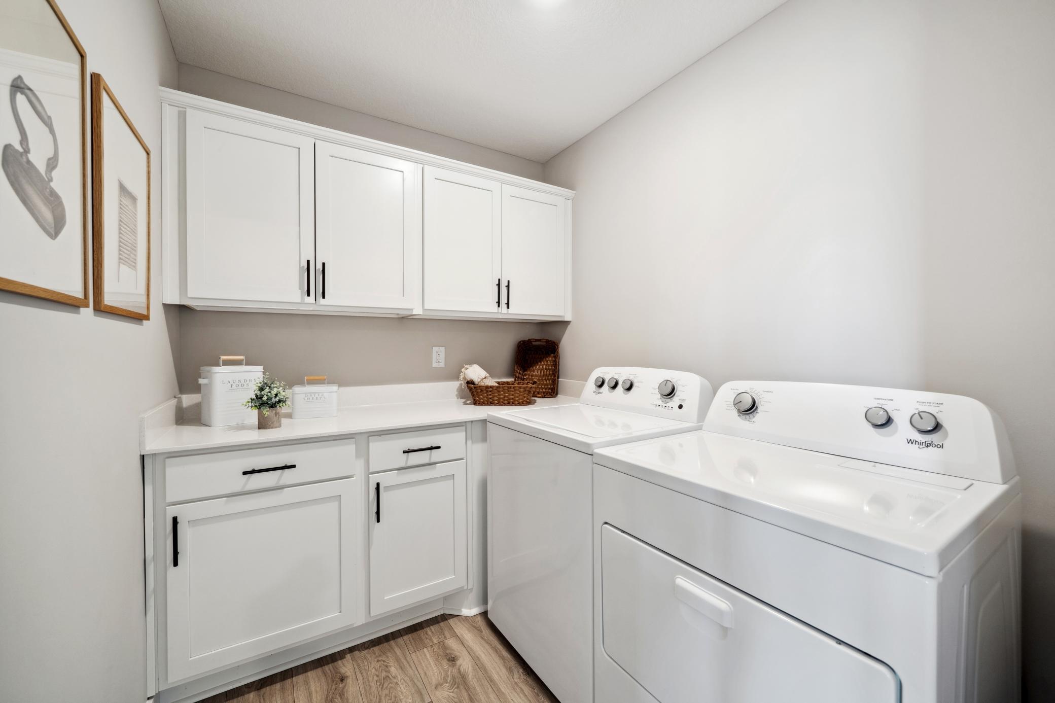 Upper level laundry with lots of storage spaces.