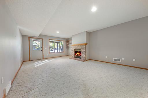 Lower Level Family Room with Gas Fireplace - Walk out Door leads to Concrete Patio