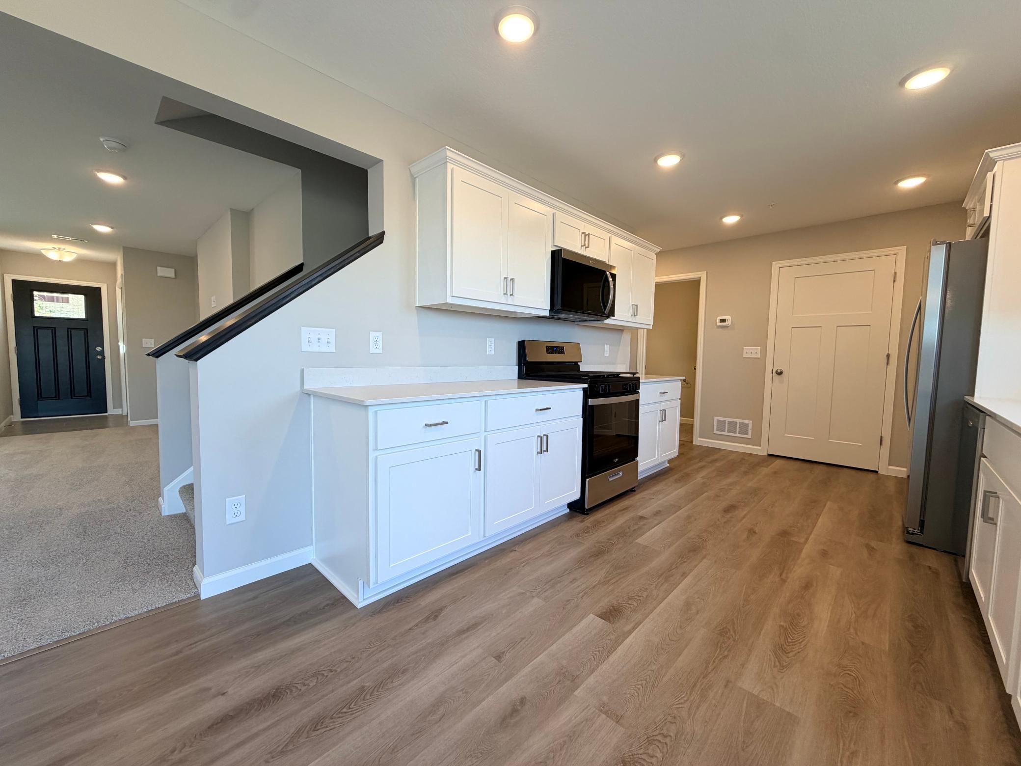 Spacious kitchen with quartz counter tops.