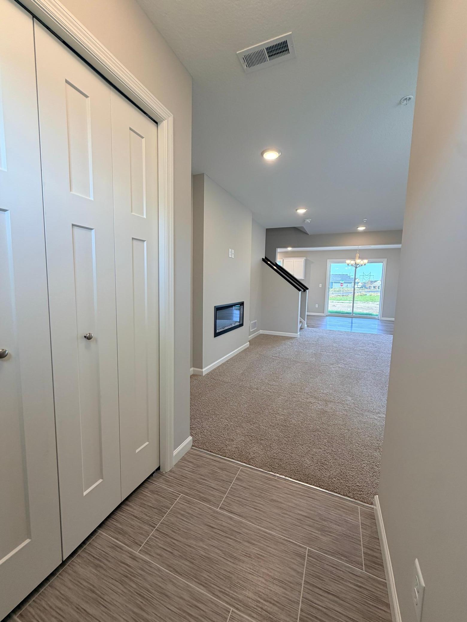 Welcoming entry with closet and luxury vinyl tile.