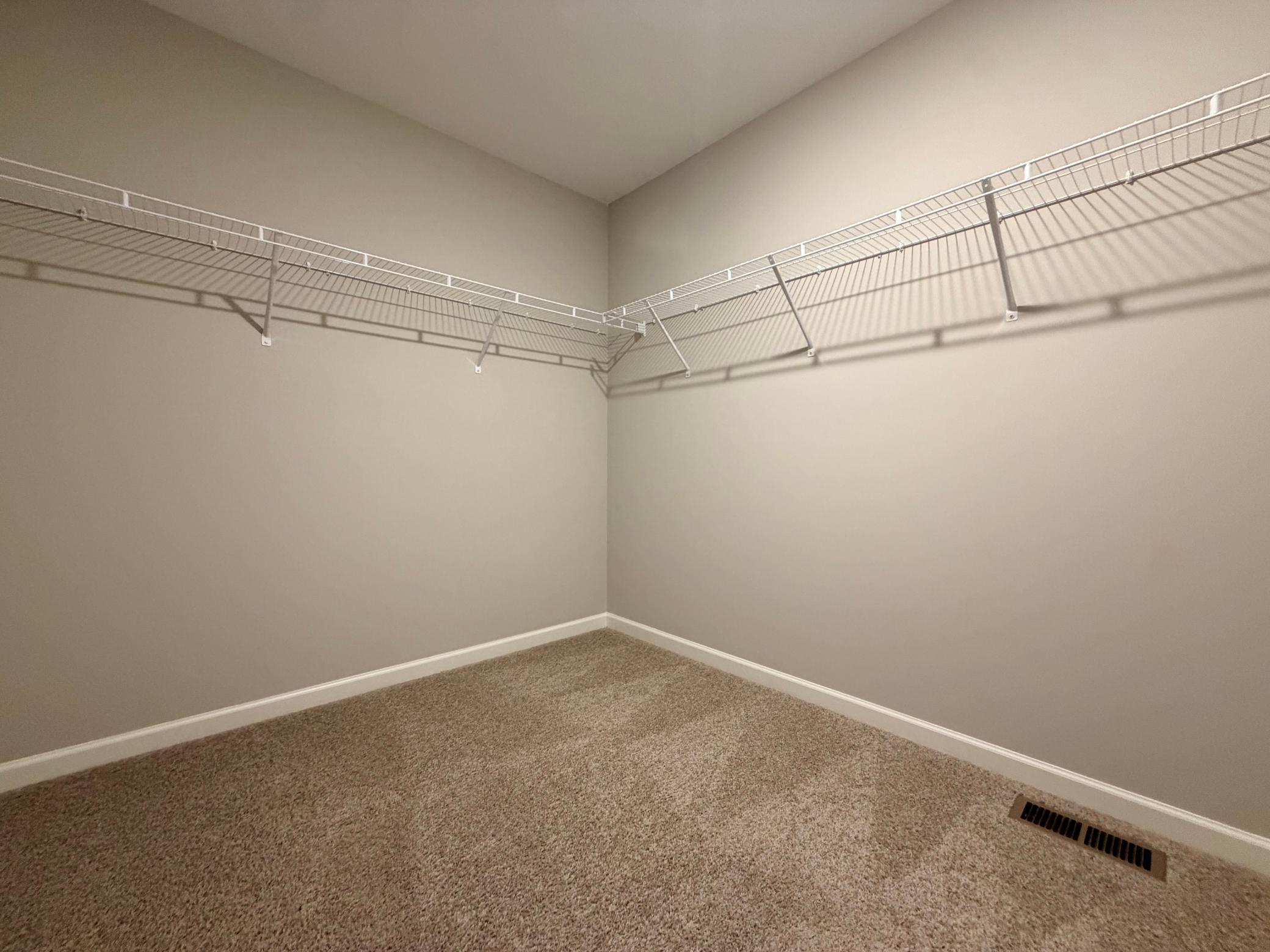 Spacious primary walk-in closet.