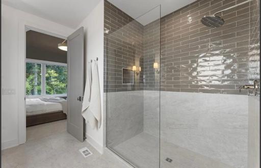 Primary with walk-in tiled shower-not actual home, photos of model with same layout