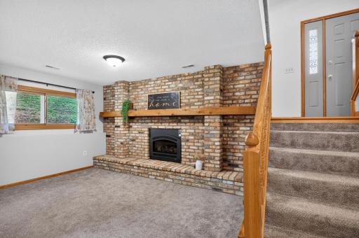 Gas fireplace on lower level with stunning brick surround