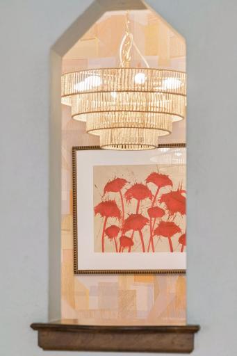 Breakfast nook detail with tiered glass chandelier and oak trim.
