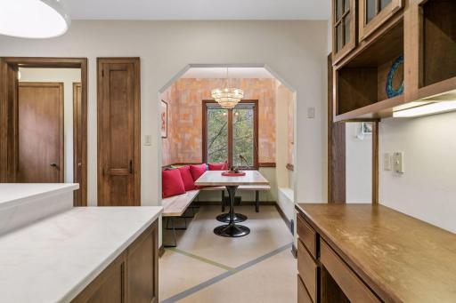 View from the kitchen through an arched opening into the breakfast nook.